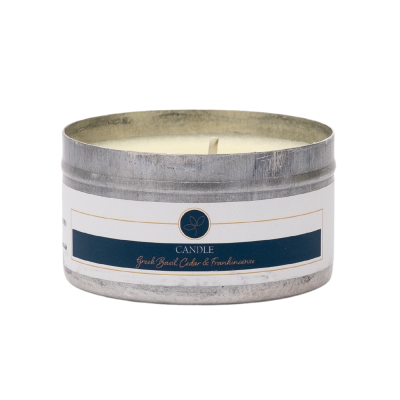 Greek basil, cedar and frankincense travel tin candle in metal tin with no lid against white background